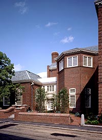 The Quincy Mutual building in present-day; a two-story brick building with grey roof and white framing around the doors and windows. = https://www.quincymutual.com/index.htm