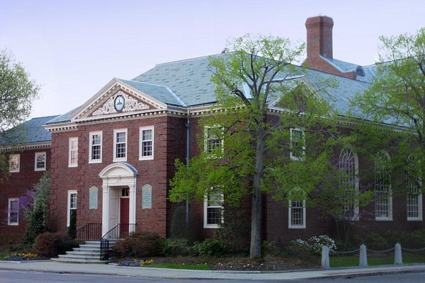 A two-story red brick building with grey roof and white framing around the windows and doors- the exterior of the Quincy Mutual building. A two-story red brick building with grey roof and white framing around the windows and doors- the exterior of the Quincy Mutual building. = https://www.quincymutual.com/index.htm