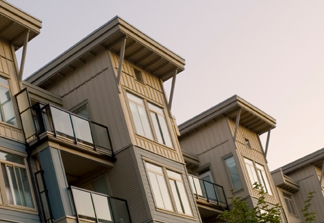 A modern apartment complex characterized by a contemporary architectural style. - https://www.quincymutual.com/